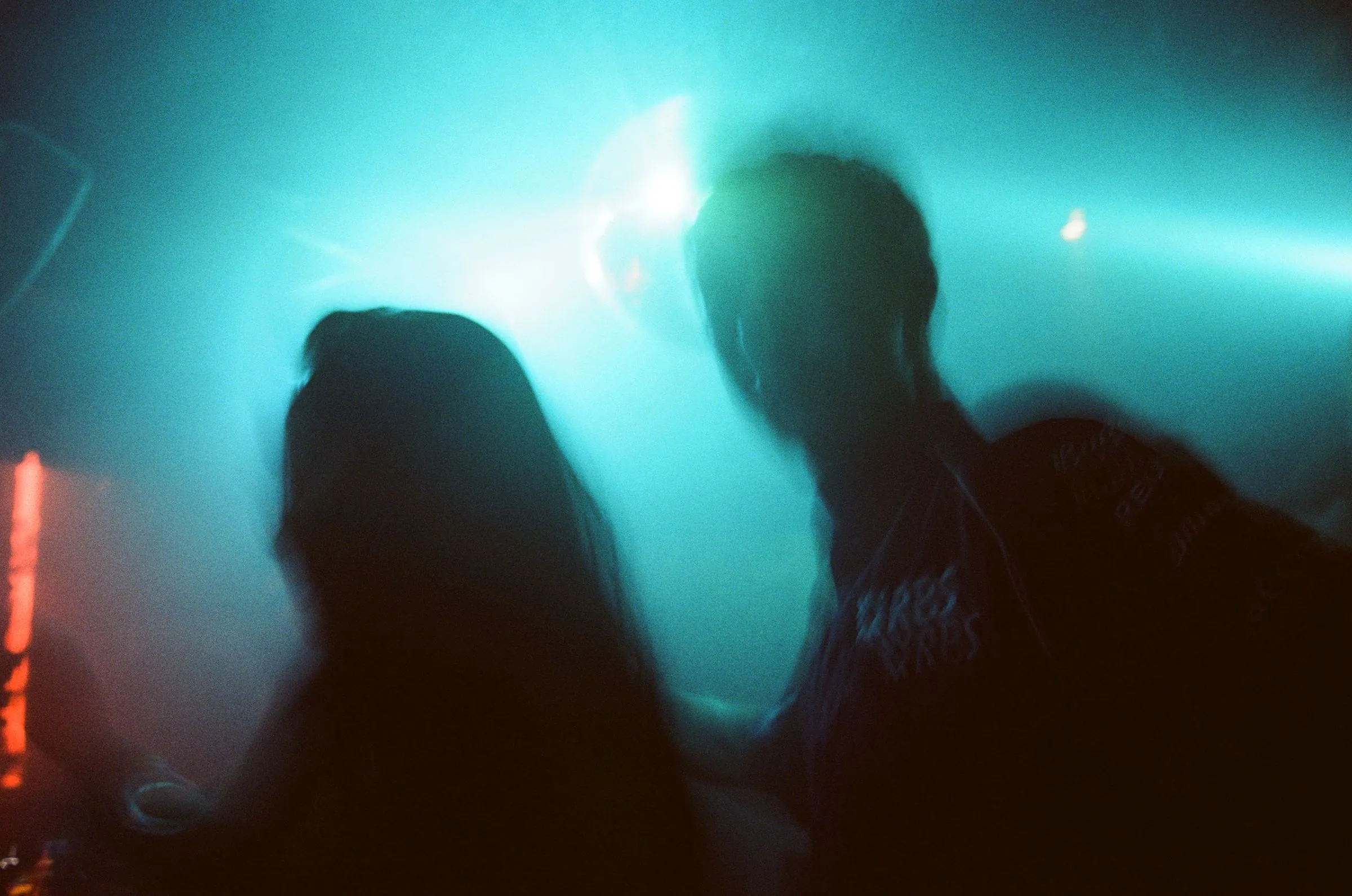 Two dancers in blue light