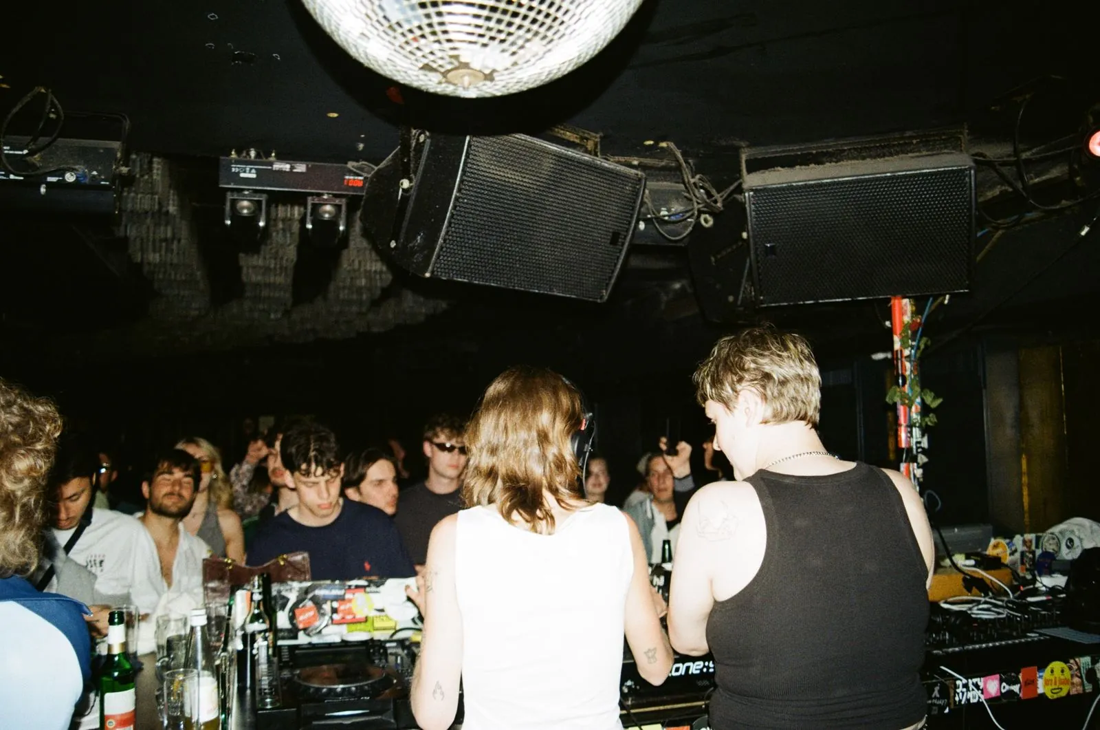A packed room around the DJ booth